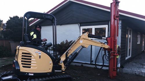 excavator mounted power head ground screw installation site